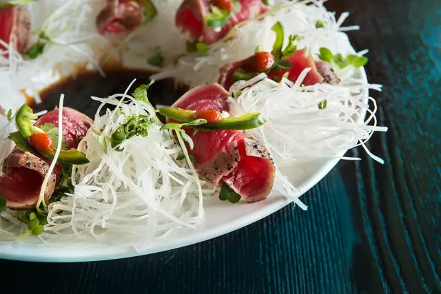 Seared tuna slices arranged over shredded daikon