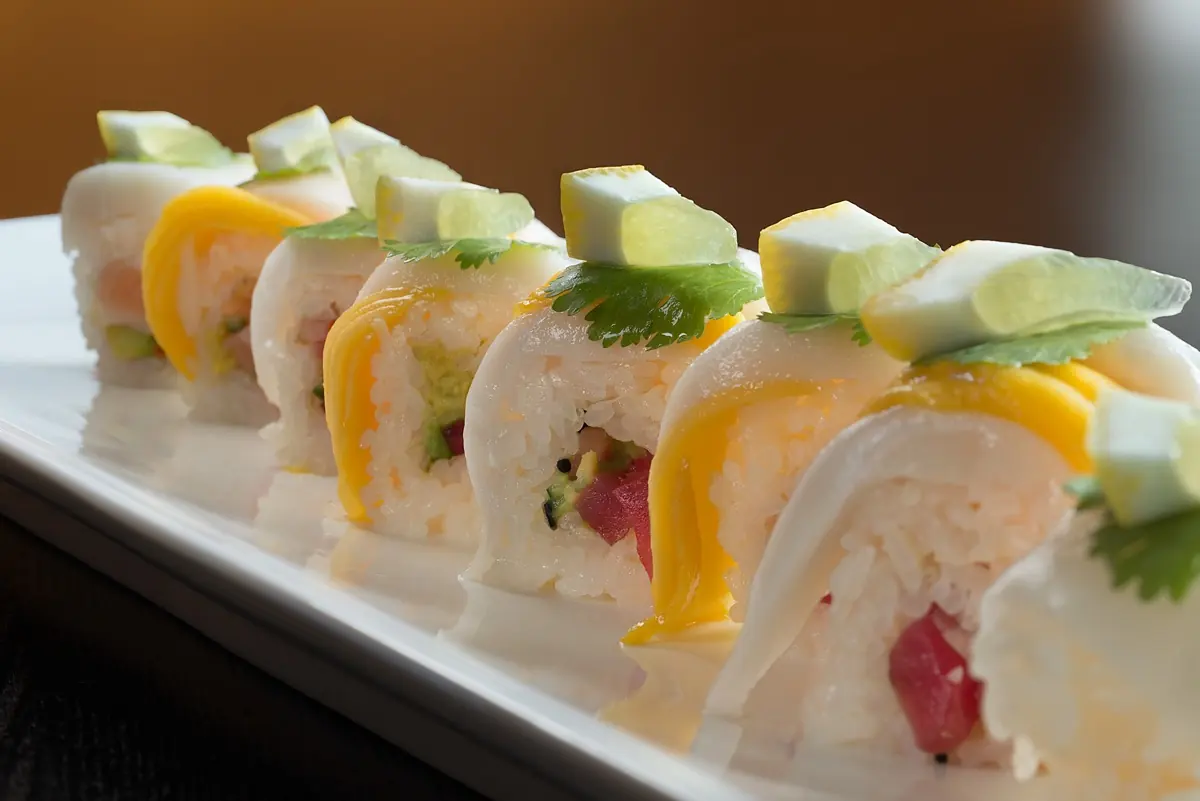 Specialty roll topped with mango and avocado slices