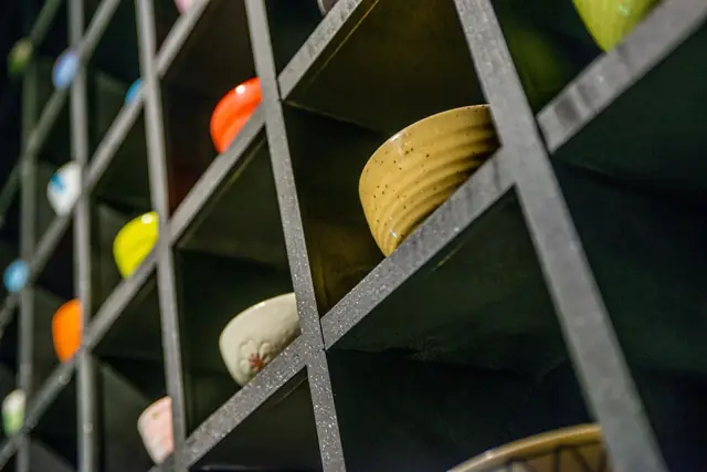 Ceramic dishes on dark wooden shelving