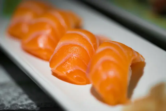 Slices of fresh salmon on a white plate
