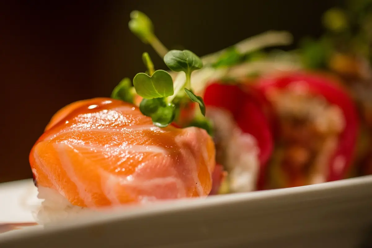 Salmon-topped roll garnished with sprouts