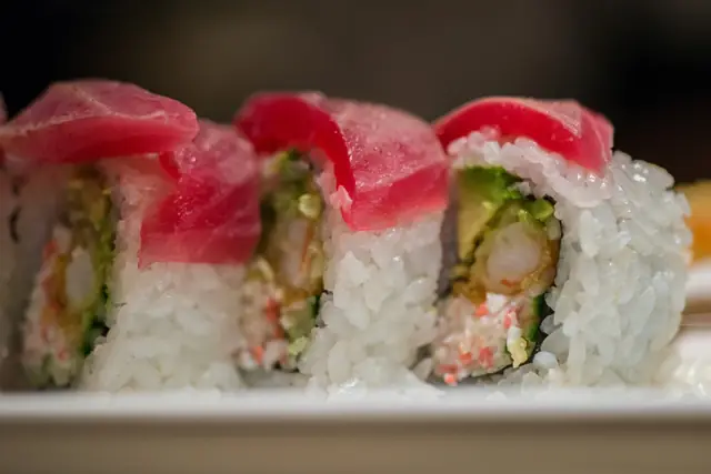 Tuna-wrapped sushi roll with cucumber and crab