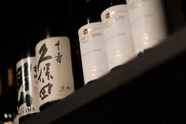 Sake bottles lined up on a shelf
